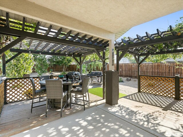 view of patio / terrace featuring a pergola, a deck, and grilling area