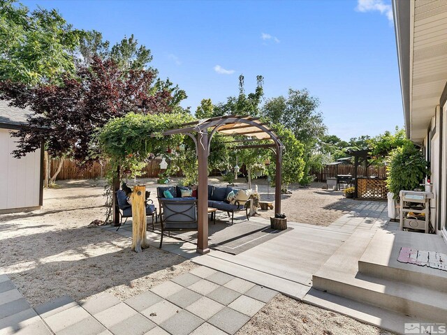 view of patio with an outdoor living space and a pergola