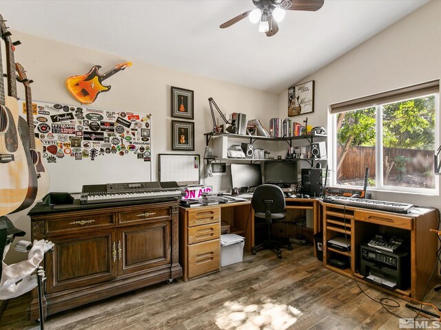 home office featuring ceiling fan, vaulted ceiling, and hardwood / wood-style floors