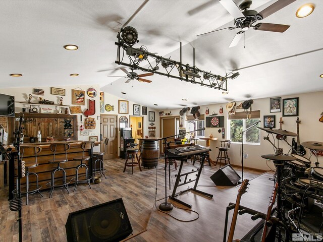 dining room featuring ceiling fan, lofted ceiling, and hardwood / wood-style flooring