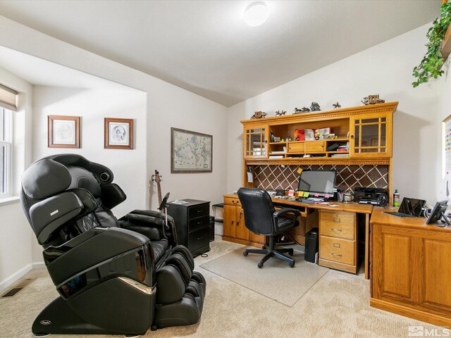 office area featuring vaulted ceiling and light carpet