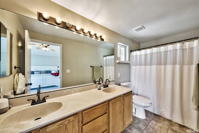 bathroom featuring ceiling fan, tile patterned flooring, vanity, and toilet