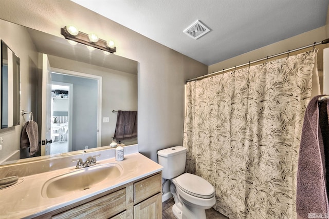 bathroom featuring tile patterned floors, toilet, and vanity