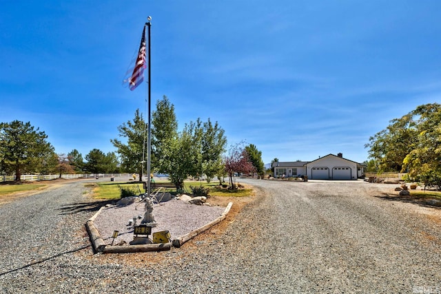 view of street with gravel driveway