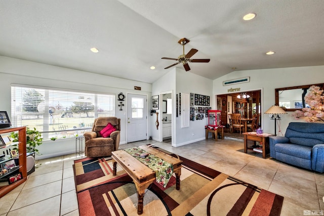 tiled living room featuring ceiling fan, lofted ceiling, and a healthy amount of sunlight