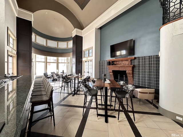 tiled dining space with high vaulted ceiling