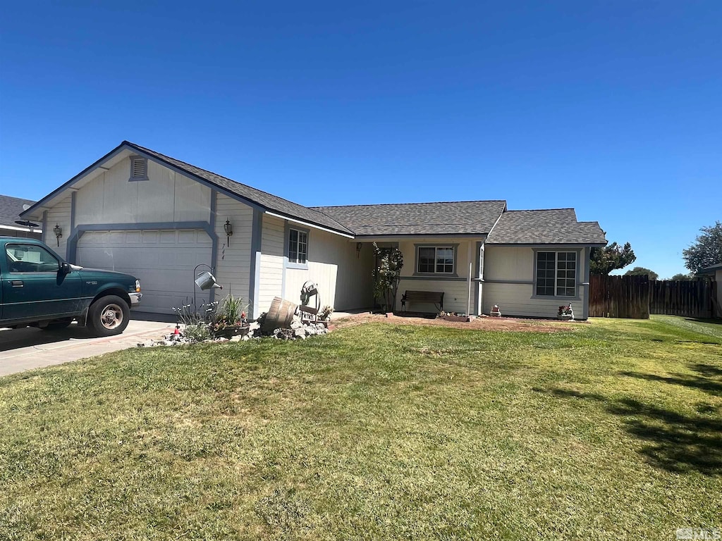 ranch-style house featuring a garage and a front yard