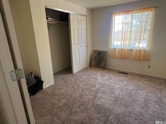 unfurnished bedroom featuring a closet and carpet floors