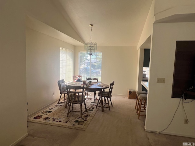 dining space featuring vaulted ceiling, a notable chandelier, and carpet floors