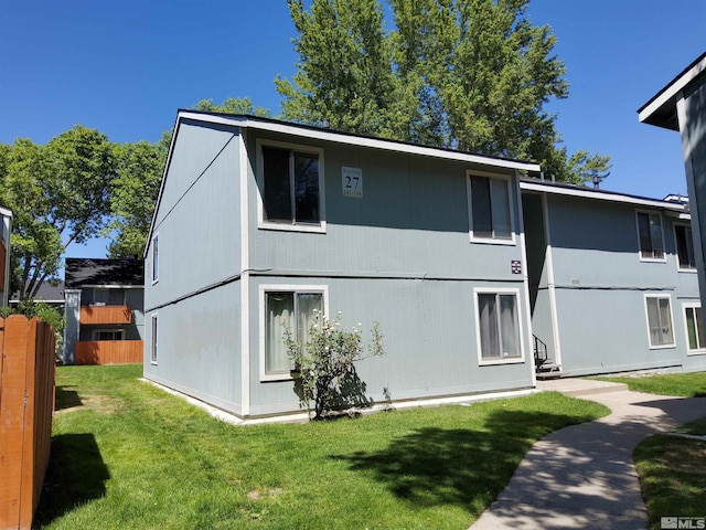 rear view of house with a yard