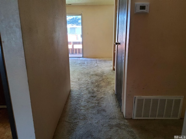 hallway featuring light colored carpet