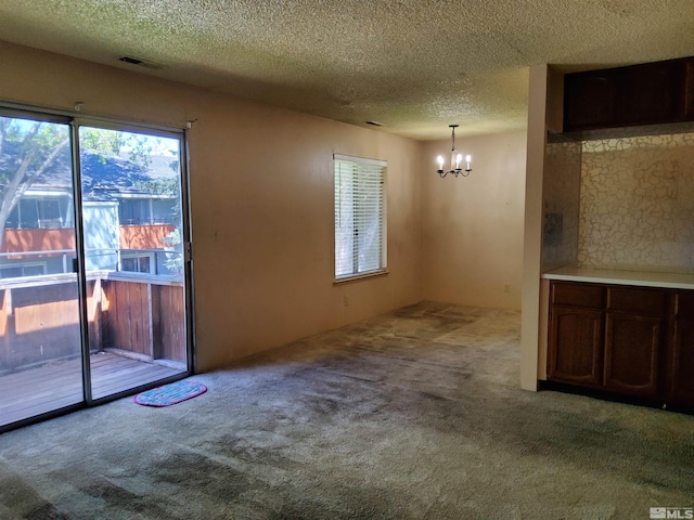 interior space with a textured ceiling, a chandelier, and light colored carpet