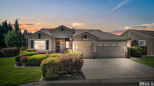 view of front facade featuring a garage, driveway, stone siding, a tiled roof, and a front lawn