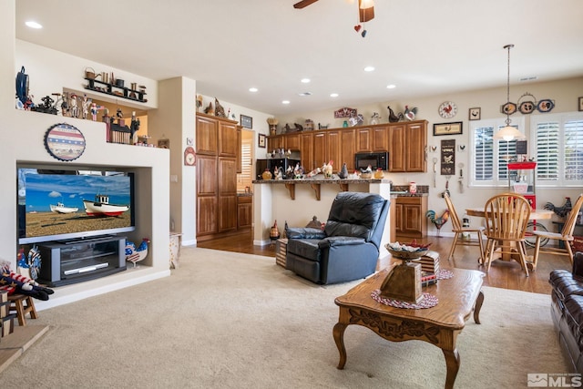 living area featuring baseboards, a ceiling fan, and recessed lighting