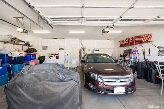 garage featuring water heater and a garage door opener