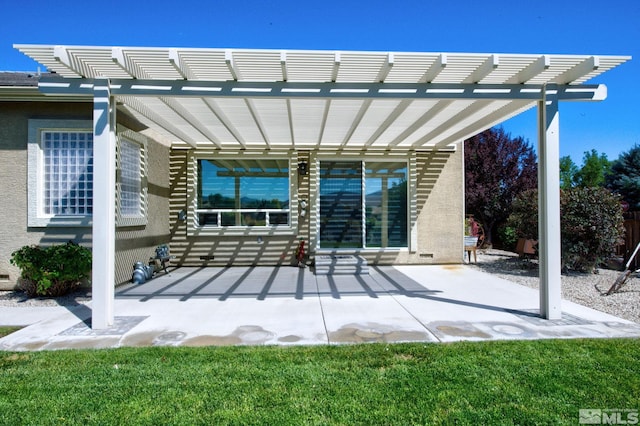 rear view of property featuring entry steps, a pergola, a patio, and stucco siding