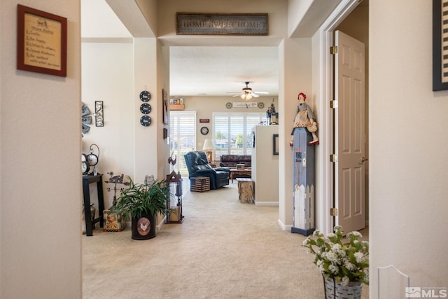 corridor featuring carpet floors and baseboards