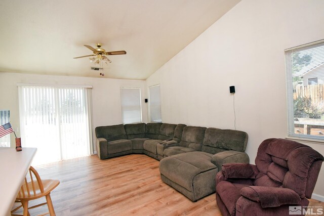 living room featuring light wood-type flooring, ceiling fan, high vaulted ceiling, and plenty of natural light