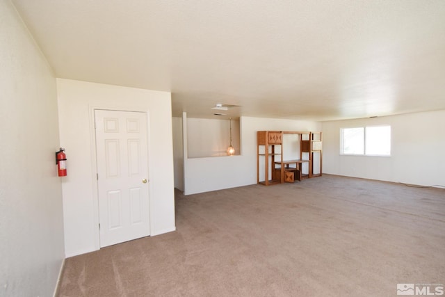 unfurnished room with light carpet