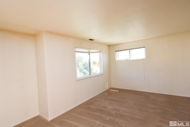 carpeted empty room with visible vents