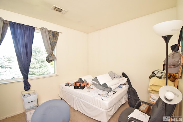 bedroom with carpet floors, multiple windows, and visible vents