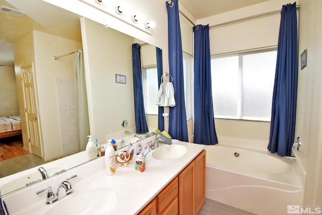 bathroom featuring vanity, hardwood / wood-style floors, and plus walk in shower