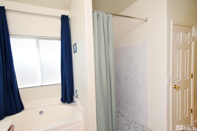 bathroom featuring a garden tub and curtained shower