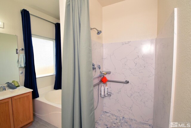 bathroom with tile patterned flooring, vanity, and separate shower and tub