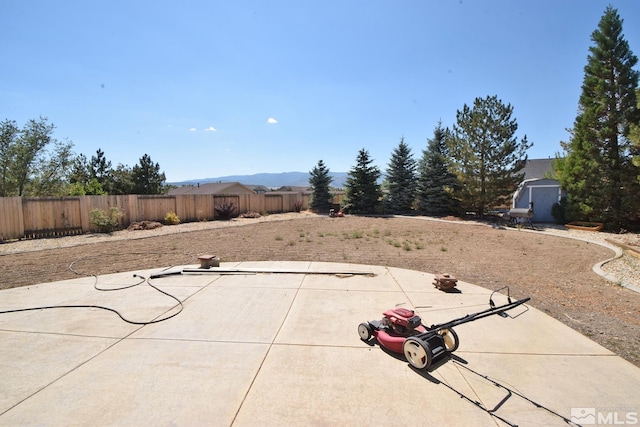 view of patio with a fenced backyard and an outbuilding