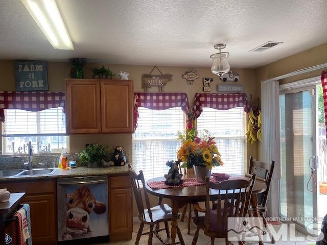 dining area featuring a textured ceiling and sink