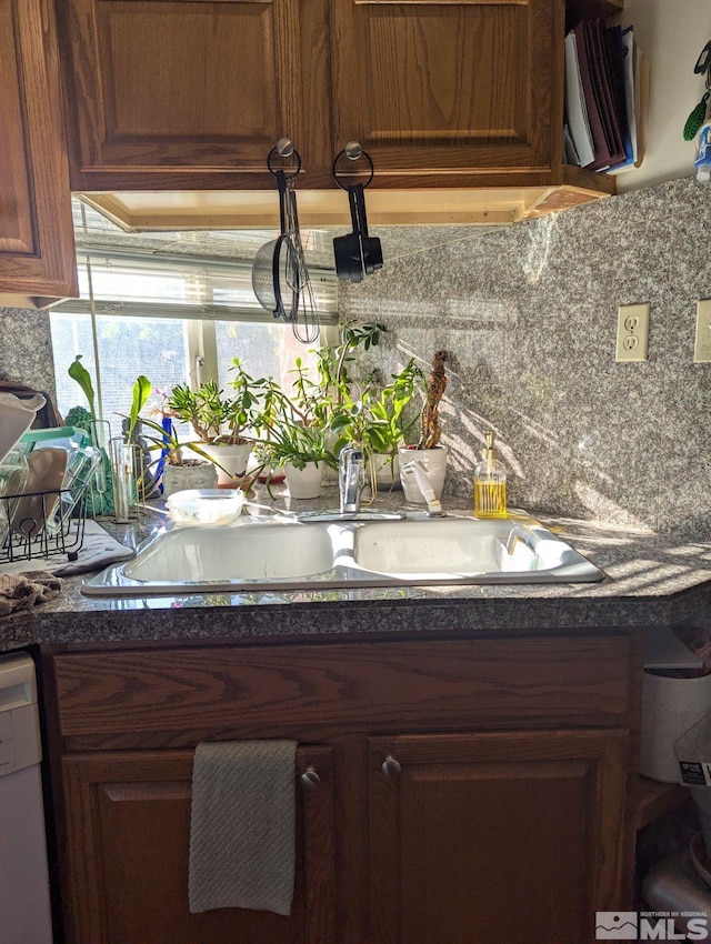 details with tasteful backsplash and white dishwasher