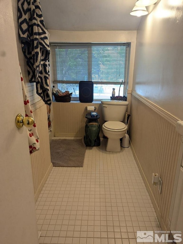 bathroom with wainscoting and toilet