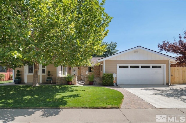 view of front of home featuring a garage and a front lawn