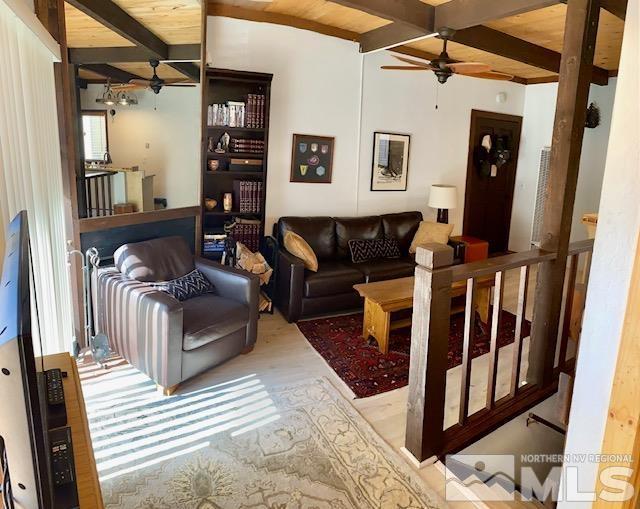 living room with wooden ceiling, beam ceiling, and ceiling fan