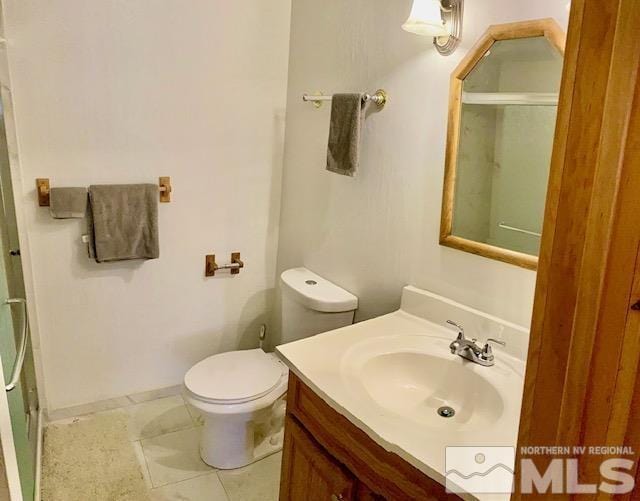 full bathroom with toilet, vanity, baseboards, tile patterned floors, and an enclosed shower