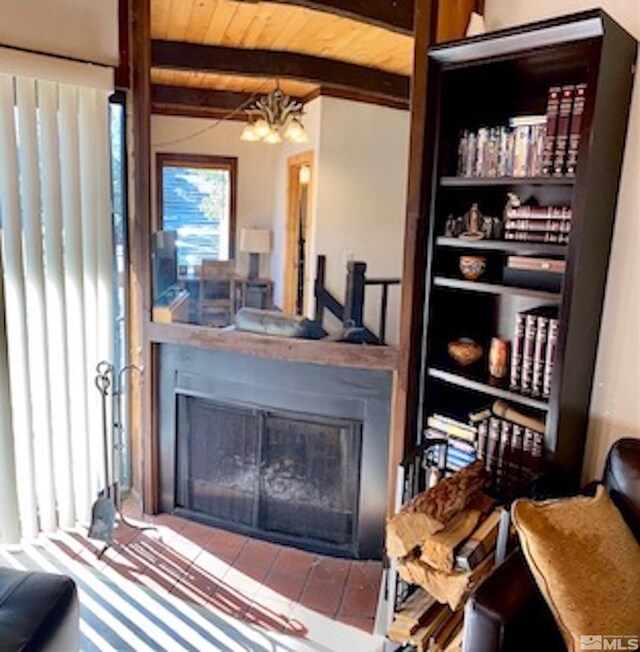 living room with beamed ceiling, a notable chandelier, and wooden ceiling