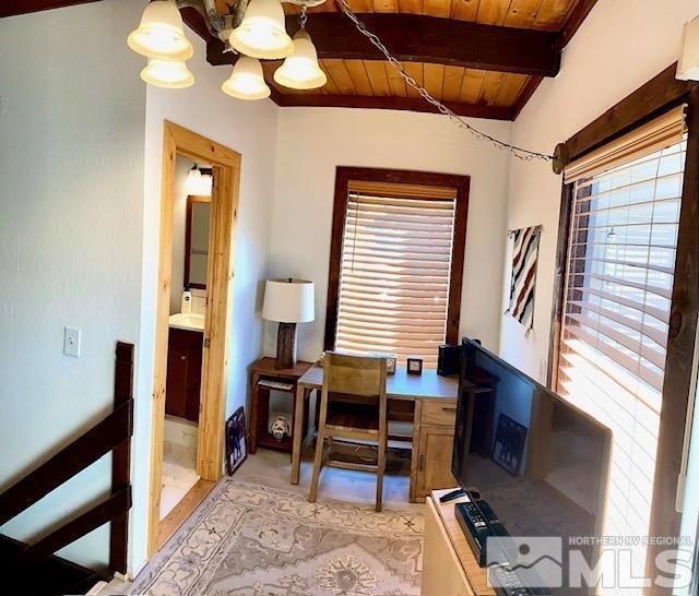 office space featuring a notable chandelier, wood ceiling, and beamed ceiling