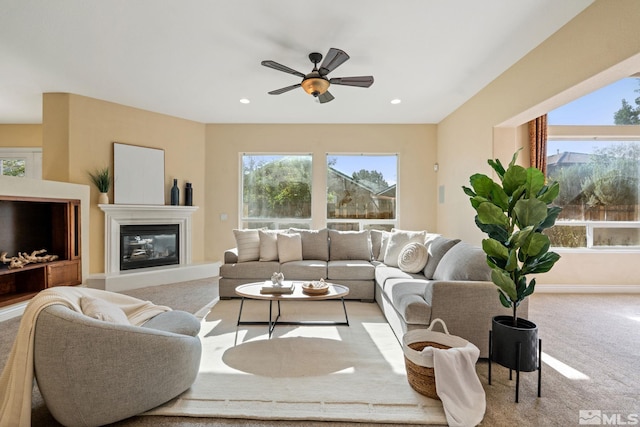 living room featuring light colored carpet and ceiling fan