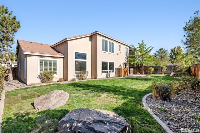 back of house featuring a yard