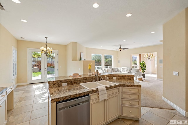 kitchen featuring ceiling fan with notable chandelier, light colored carpet, sink, a kitchen island with sink, and stainless steel dishwasher