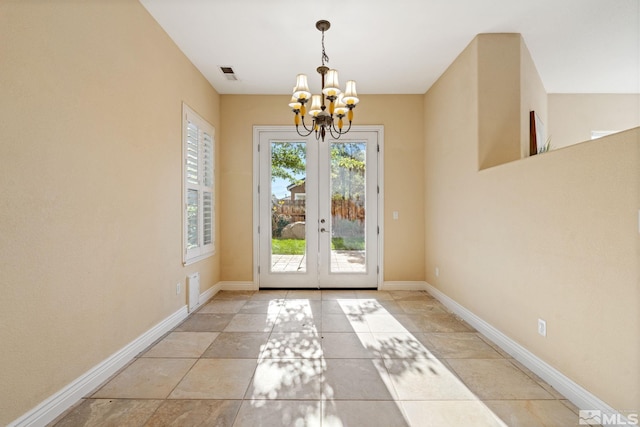 doorway with french doors and a chandelier