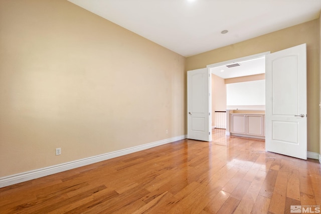 unfurnished bedroom featuring light wood-type flooring