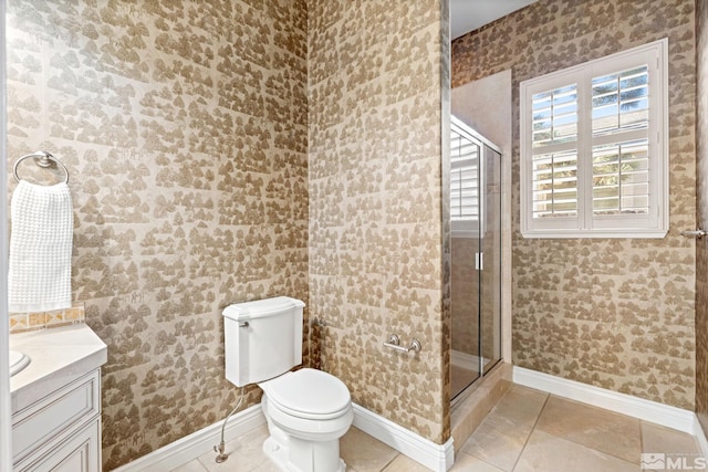 bathroom with vanity, toilet, walk in shower, and tile patterned flooring