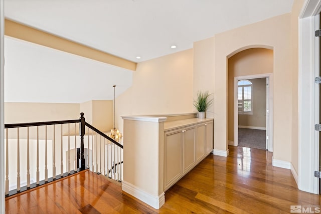 hall featuring a notable chandelier and wood-type flooring