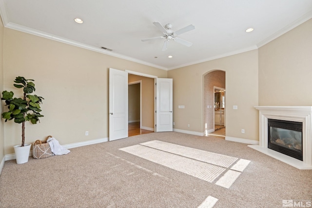 unfurnished living room with ceiling fan, light colored carpet, and ornamental molding