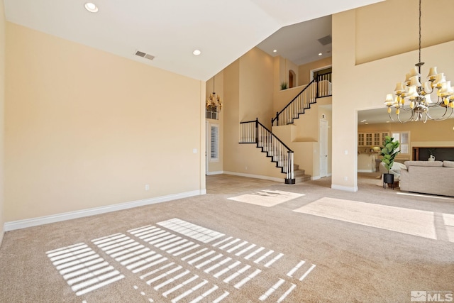 interior space featuring an inviting chandelier, light carpet, and high vaulted ceiling