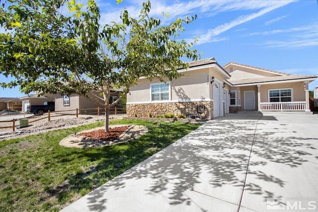 ranch-style house with stucco siding, concrete driveway, a garage, stone siding, and a front lawn