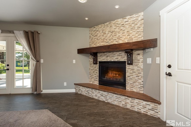 unfurnished living room featuring a fireplace and french doors