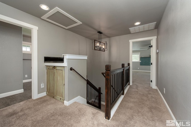 stairway with a wealth of natural light and carpet