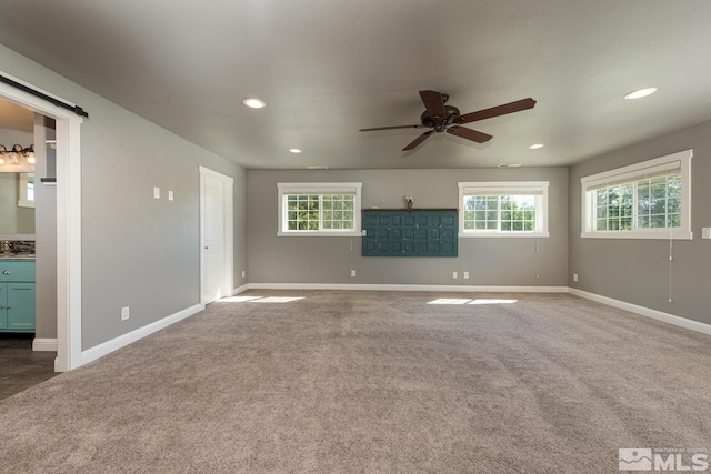 empty room with ceiling fan and carpet